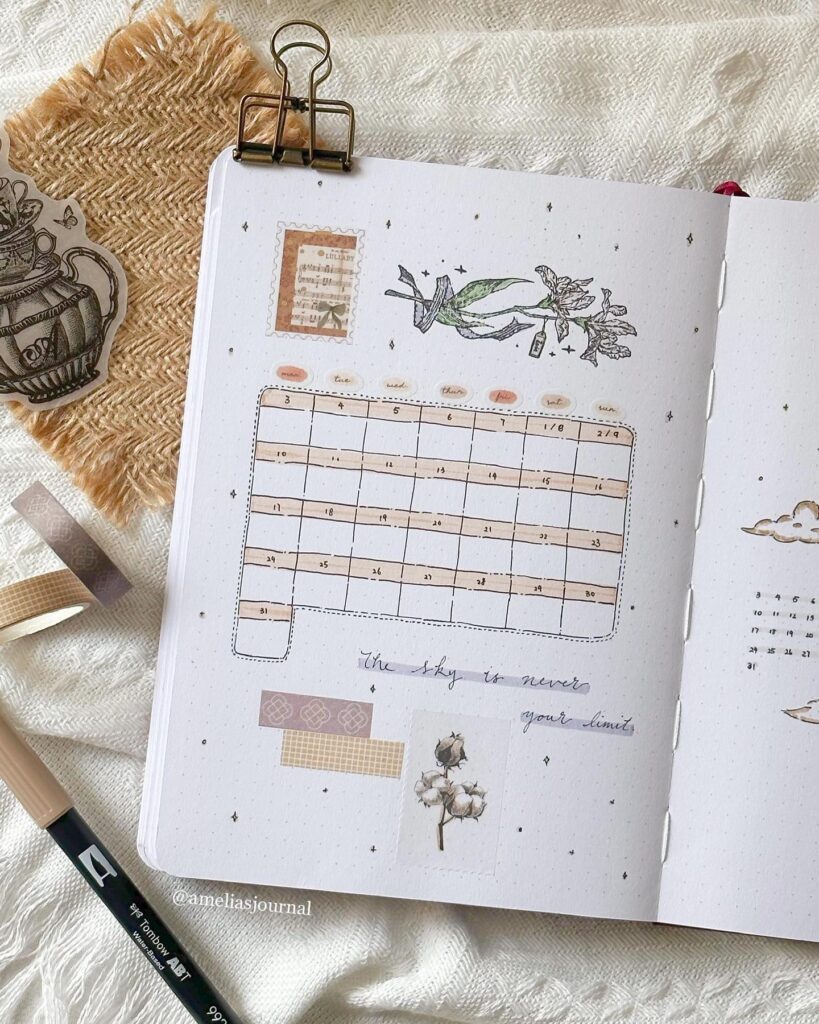 Decorative bullet journal with floral motifs, calendar layout, artistic washi tape, and motivational quote.