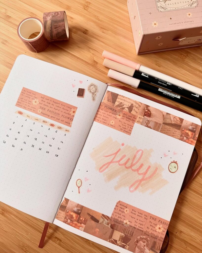 Bullet journal open to a July spread, decorated with washi tape and pens on a wooden desk.