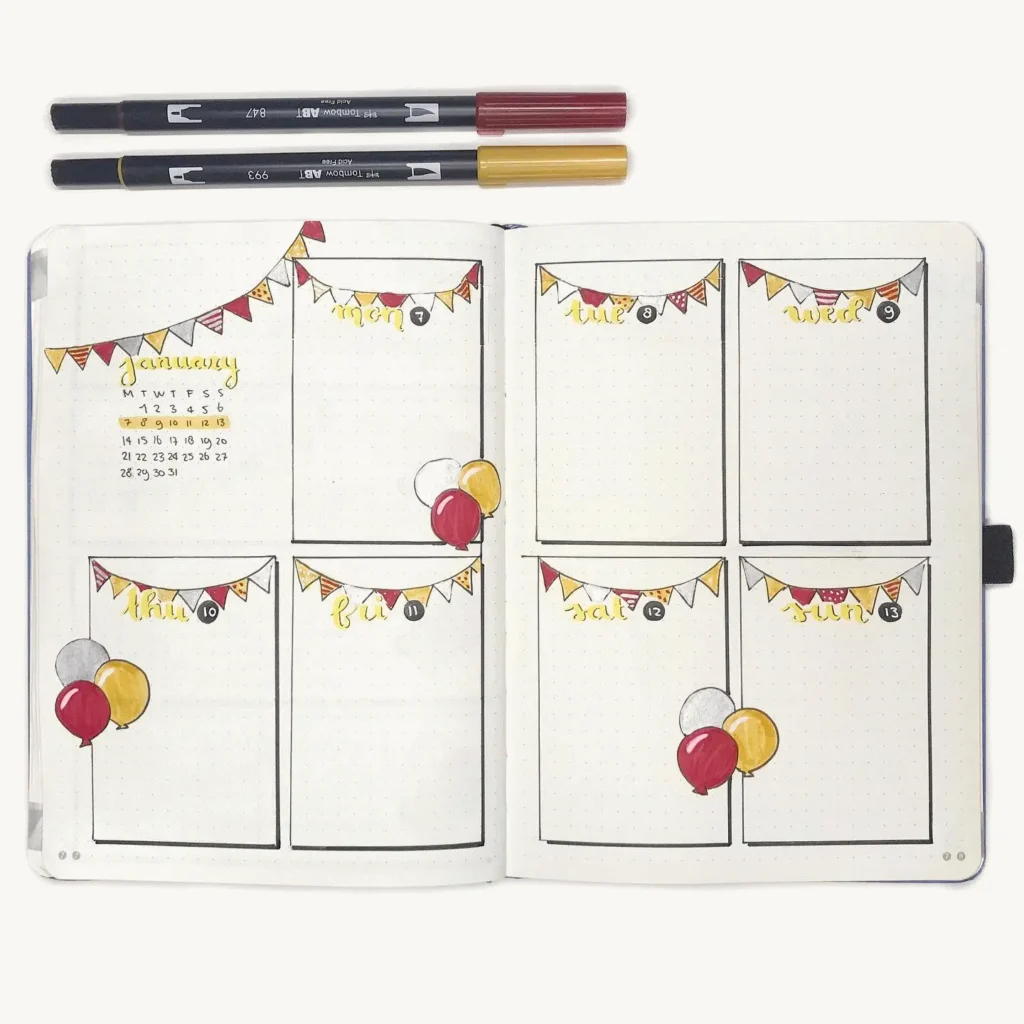 Decorative bullet journal weekly spread with colorful banners and balloons, January calendar, and two pens on top.