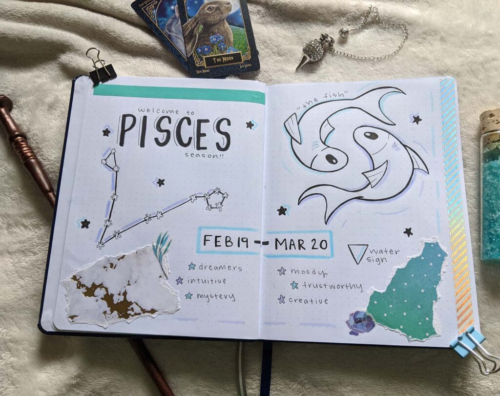 Pisces season journal spread with constellation, symbols, and traits like dreamers, intuitive, and creative.