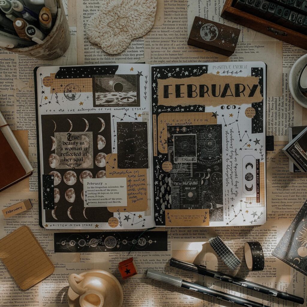 Creative February journal layout with celestial theme, featuring moon phases and inspirational quotes.