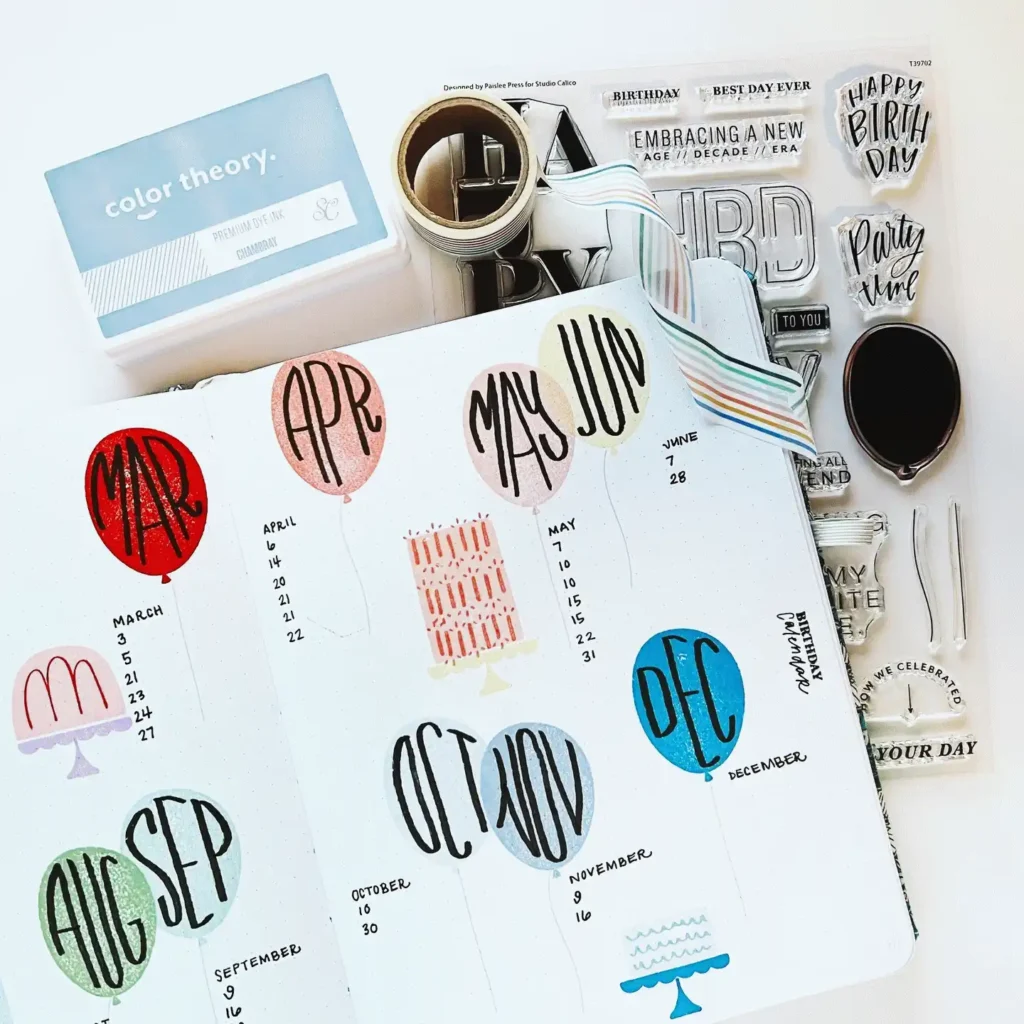 Colorful bullet journal spread with monthly overviews, washi tape, and stamps for planner or scrapbook design.