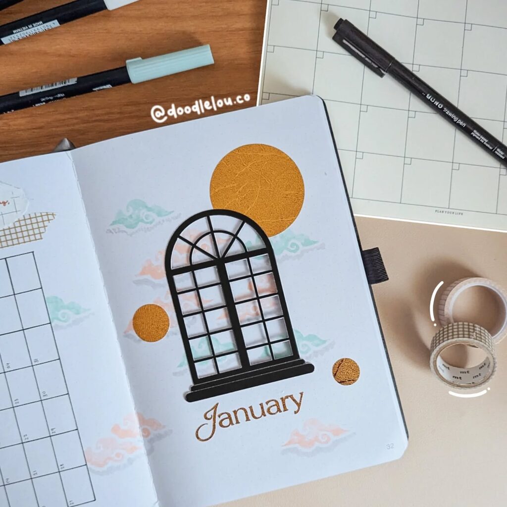 January planner page with decorative window design, markers, and washi tape on a desk.