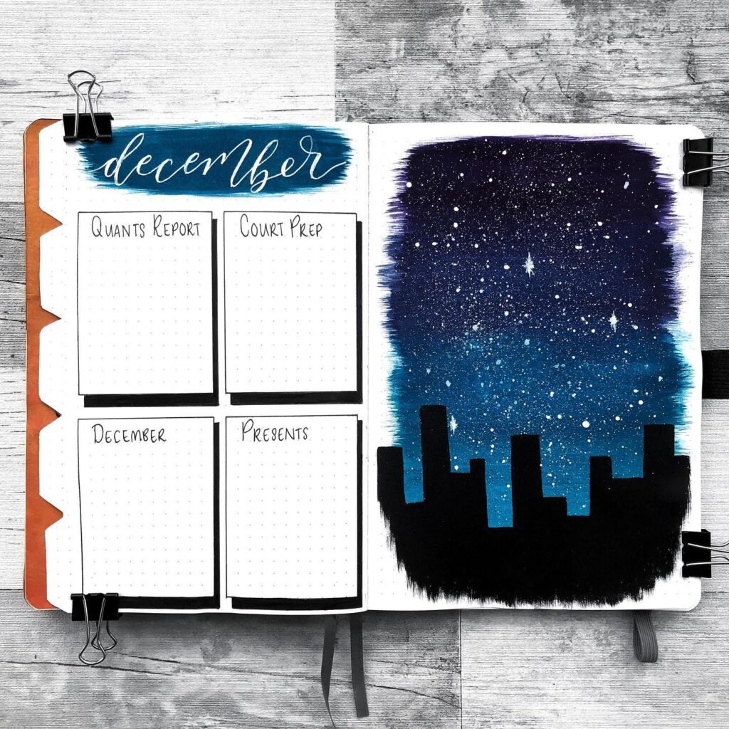 December bullet journal with task lists and a starry night cityscape illustration.