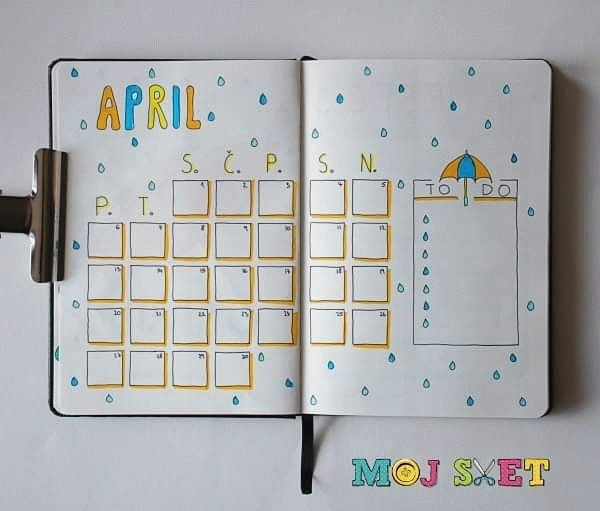 Open journal with April calendar layout and raindrop theme. To-do list with umbrella illustration on the right page.