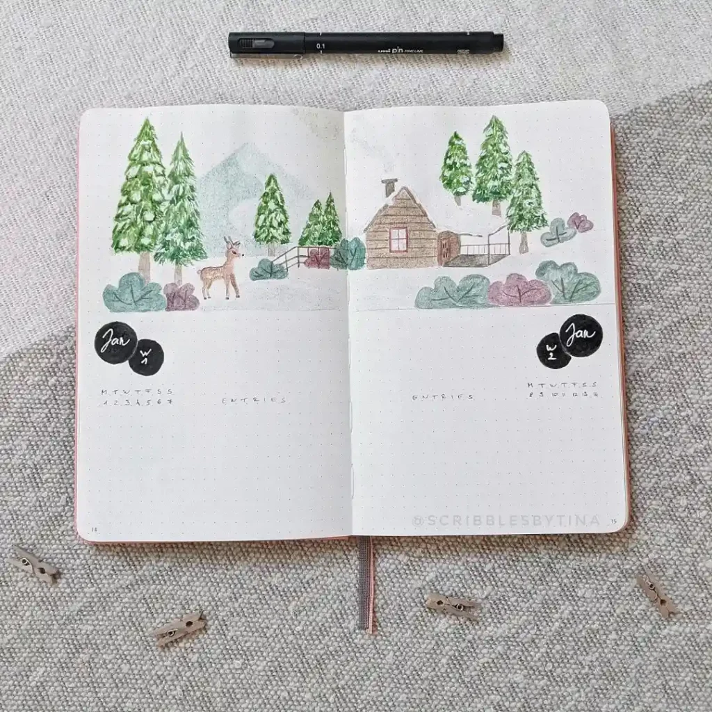 Open journal with hand-drawn cabin, trees, and deer illustration. Bullet journal layout for January planning.