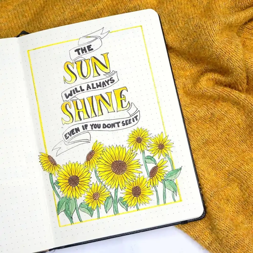 Handwritten quote 'The sun will always shine even if you don't see it' surrounded by vibrant sunflowers in a notebook.
