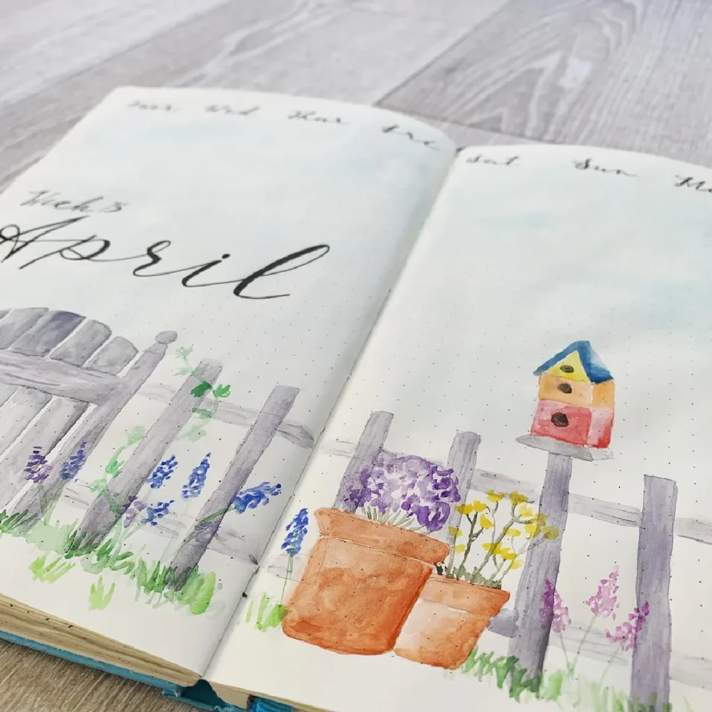 Colorful bullet journal pages for April featuring flowers, a birdhouse, and a rustic fence illustration.