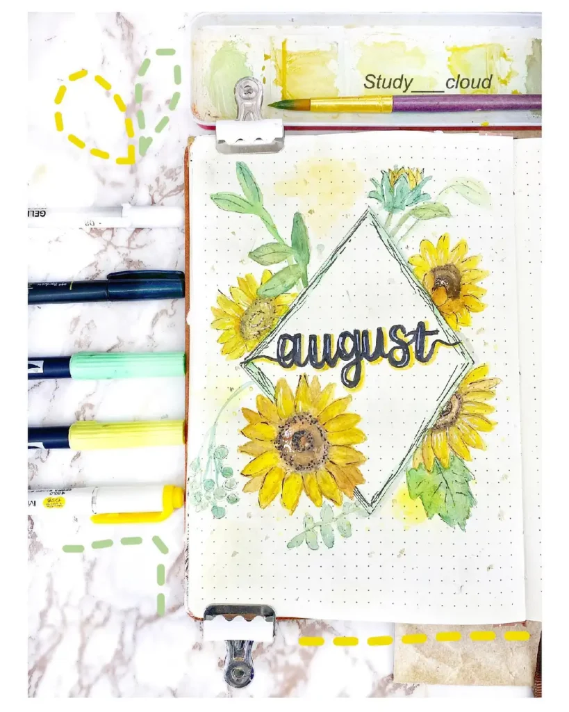 Bullet journal page for August featuring hand-drawn sunflowers, watercolors, and colorful pens on a marble background.