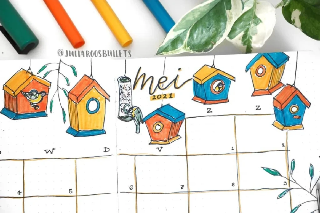 Colorful bullet journal spread for May 2021 featuring hand-drawn birdhouses, notes, and decorative leaves.