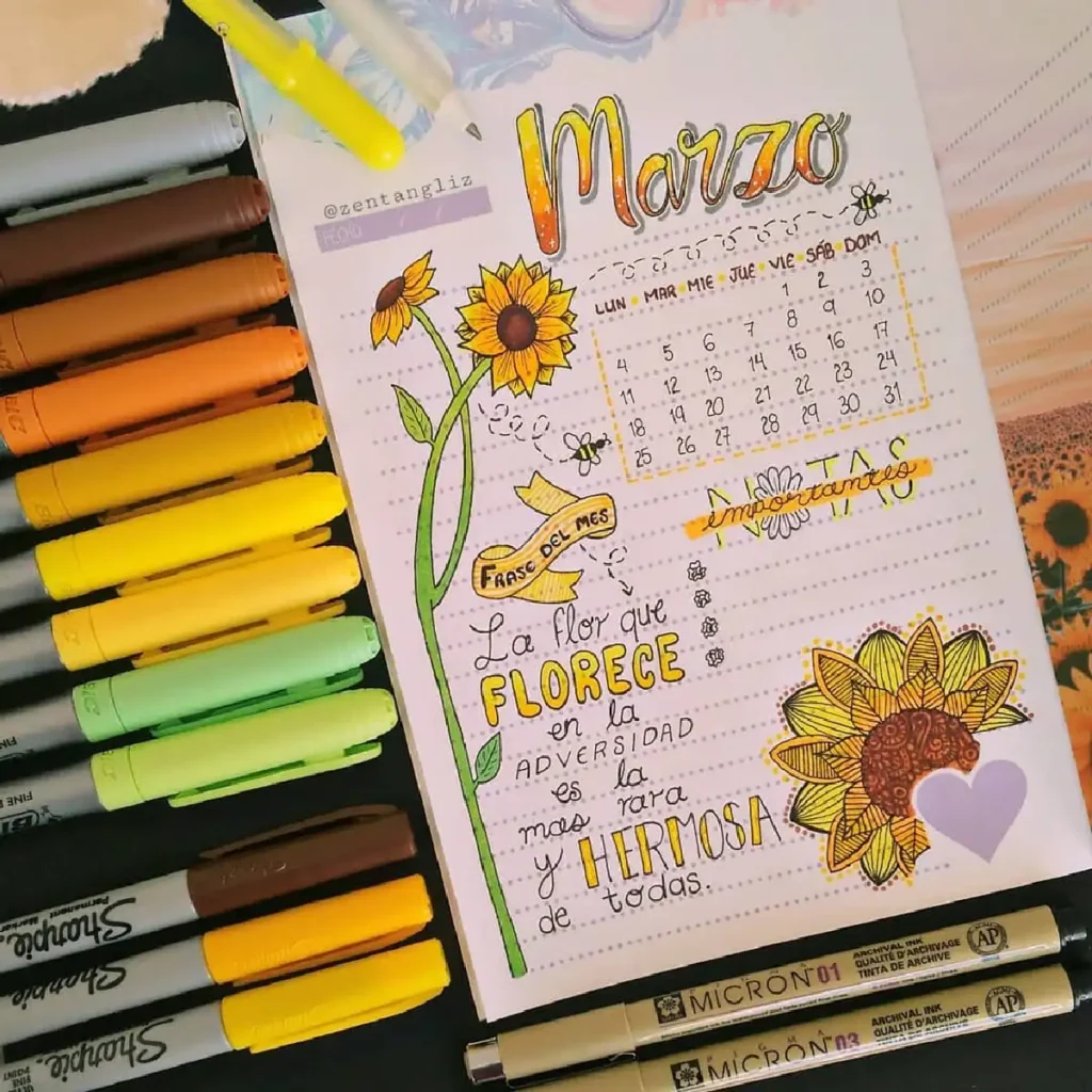 Colorful March calendar page with sunflowers and inspirational quote, surrounded by vibrant markers and pens.