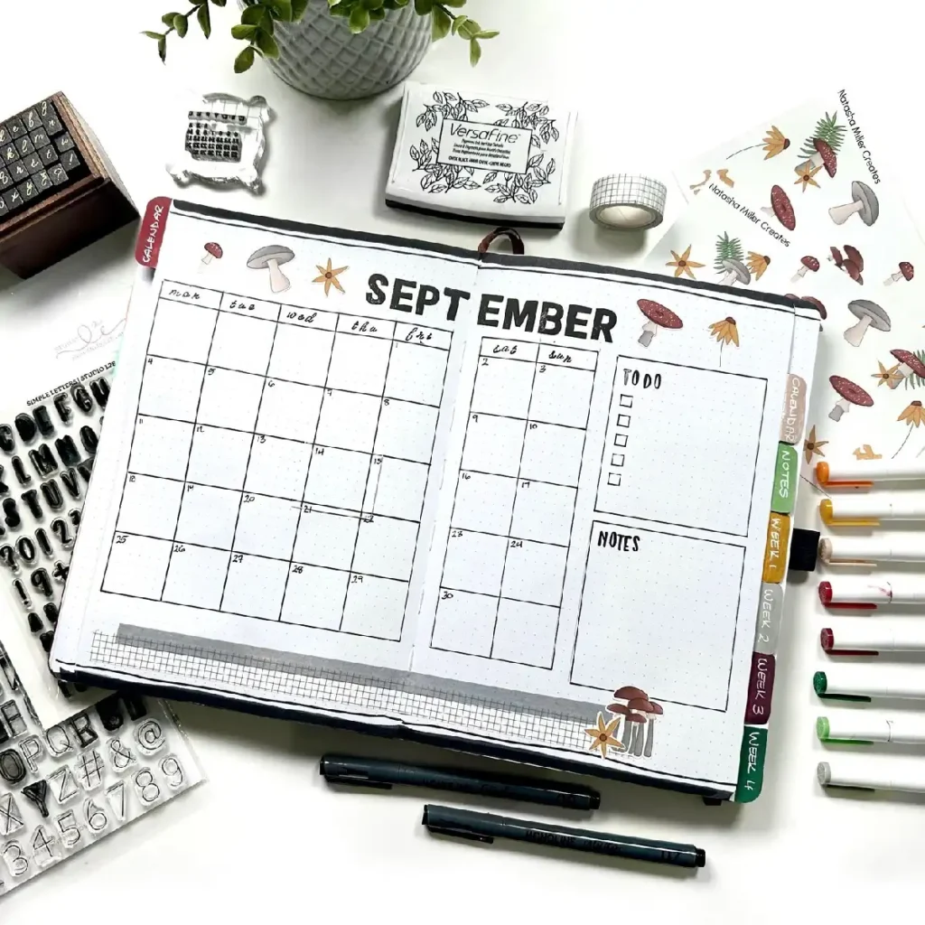 Stylish September bullet journal layout featuring a calendar, to-do list, and colorful pens on a desk.