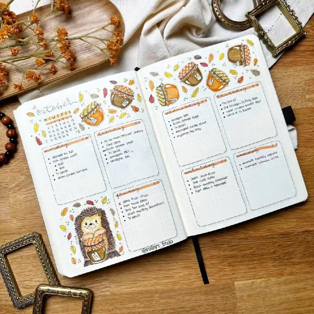 Bujo spread for October featuring a hedgehog and seasonal decorations, with to-do lists and goals for the month.