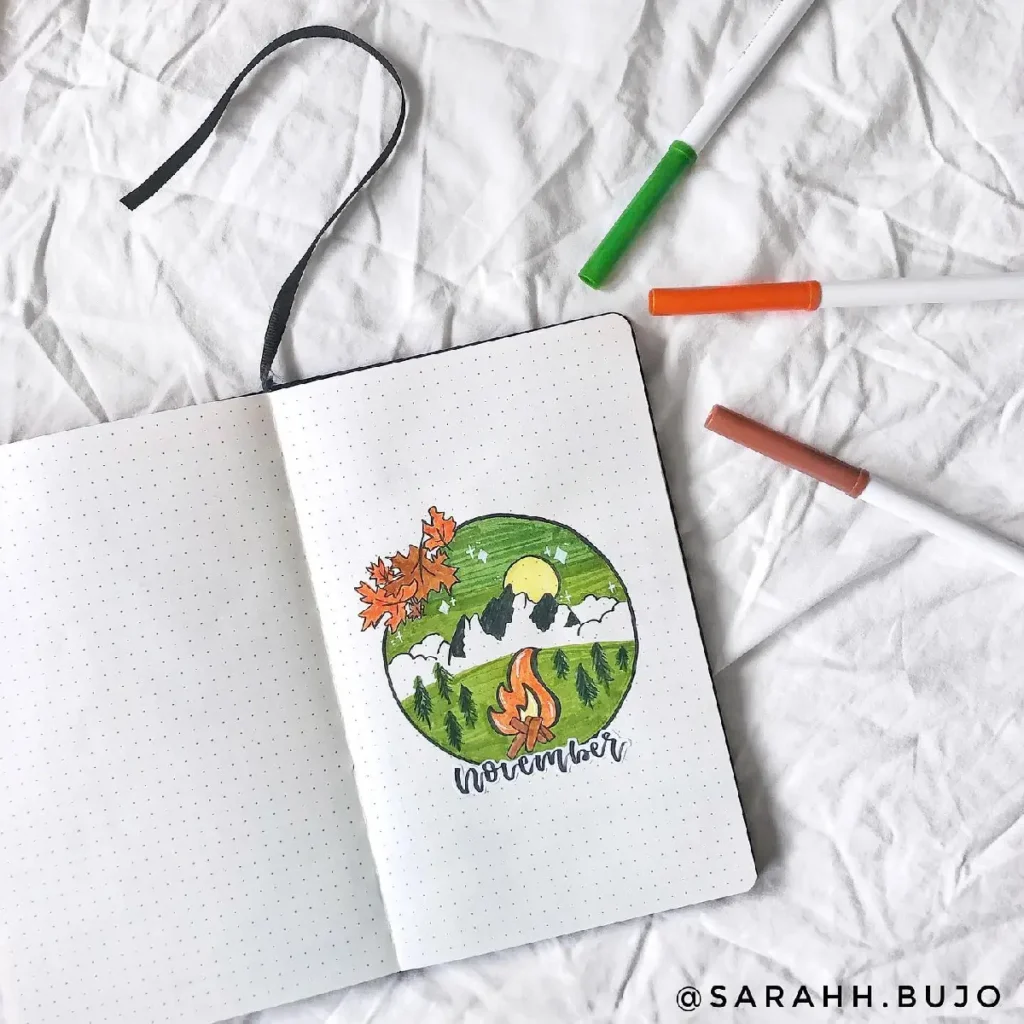 Colorful November bullet journal spread featuring autumn leaves, mountains, and a campfire illustration.
