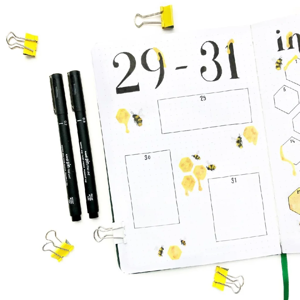 Bullet journal page for dates 29-31, featuring black markers, honeycomb illustrations, and yellow binder clips.