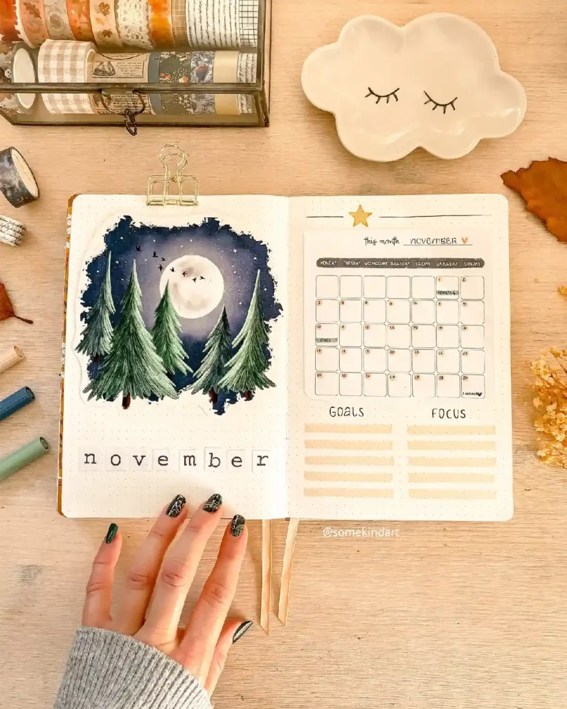 Cozy bullet journal page for November featuring a moonlit forest scene, calendar, and goal-setting sections.