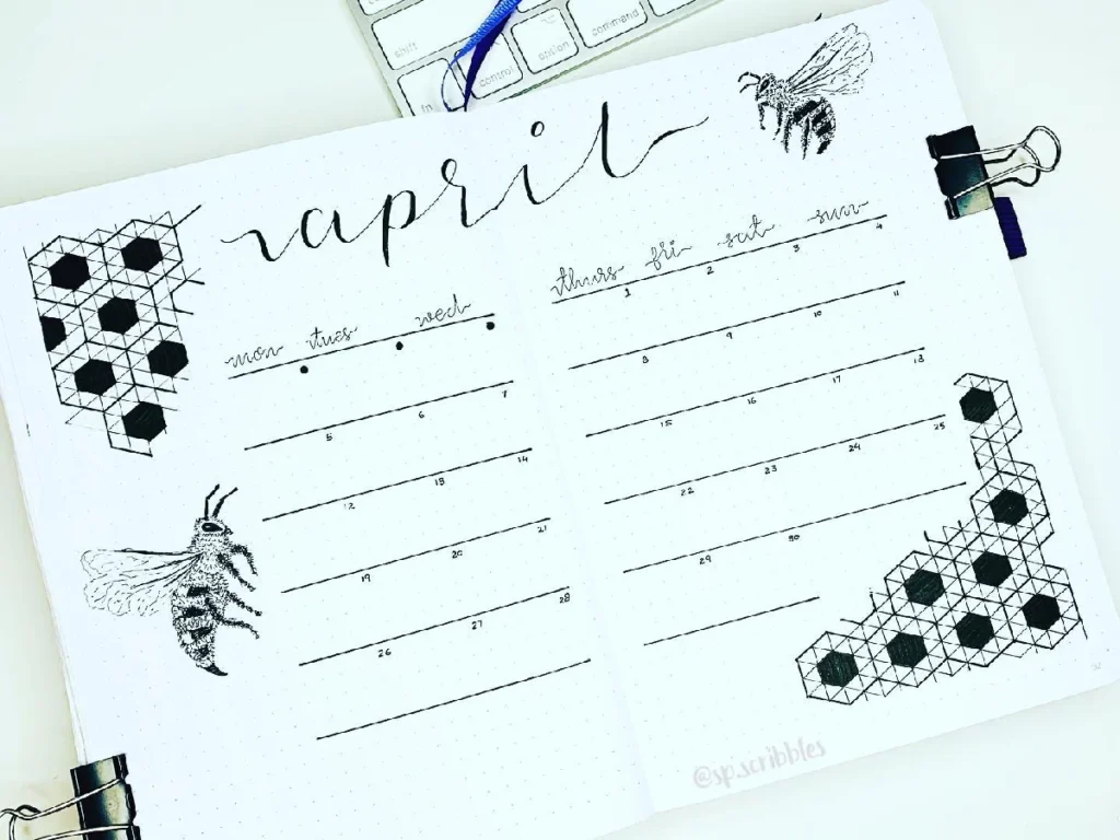 Bullet journal spread for April featuring bee illustrations and hexagonal designs, with weekly planner sections.