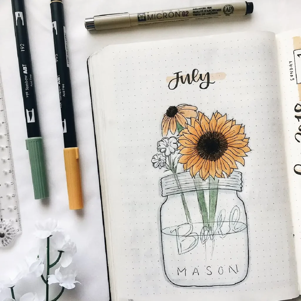 Bullet journal page for July featuring hand-drawn sunflowers in a glass mason jar with colored pens.