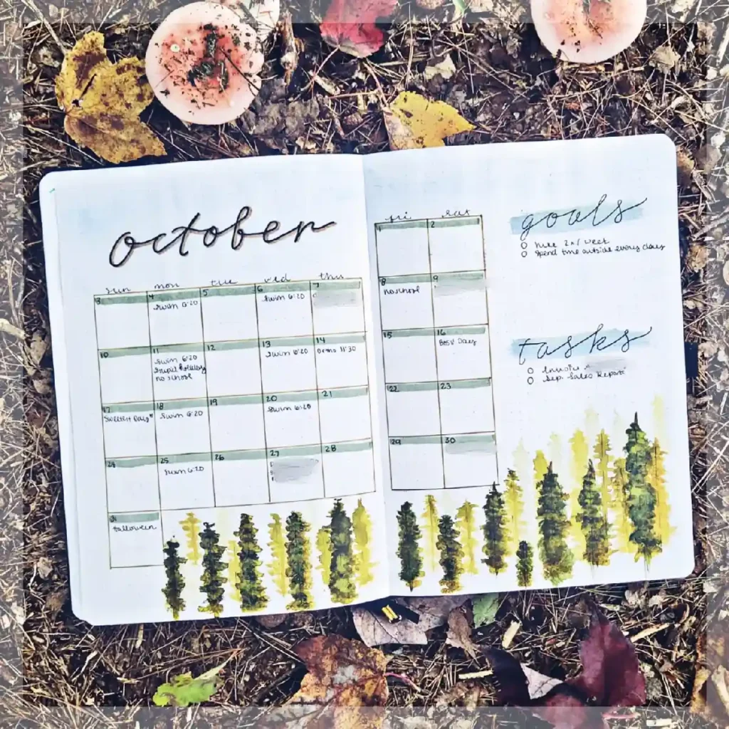 October bullet journal spread with calendar, goals, and task details on a background of autumn leaves.