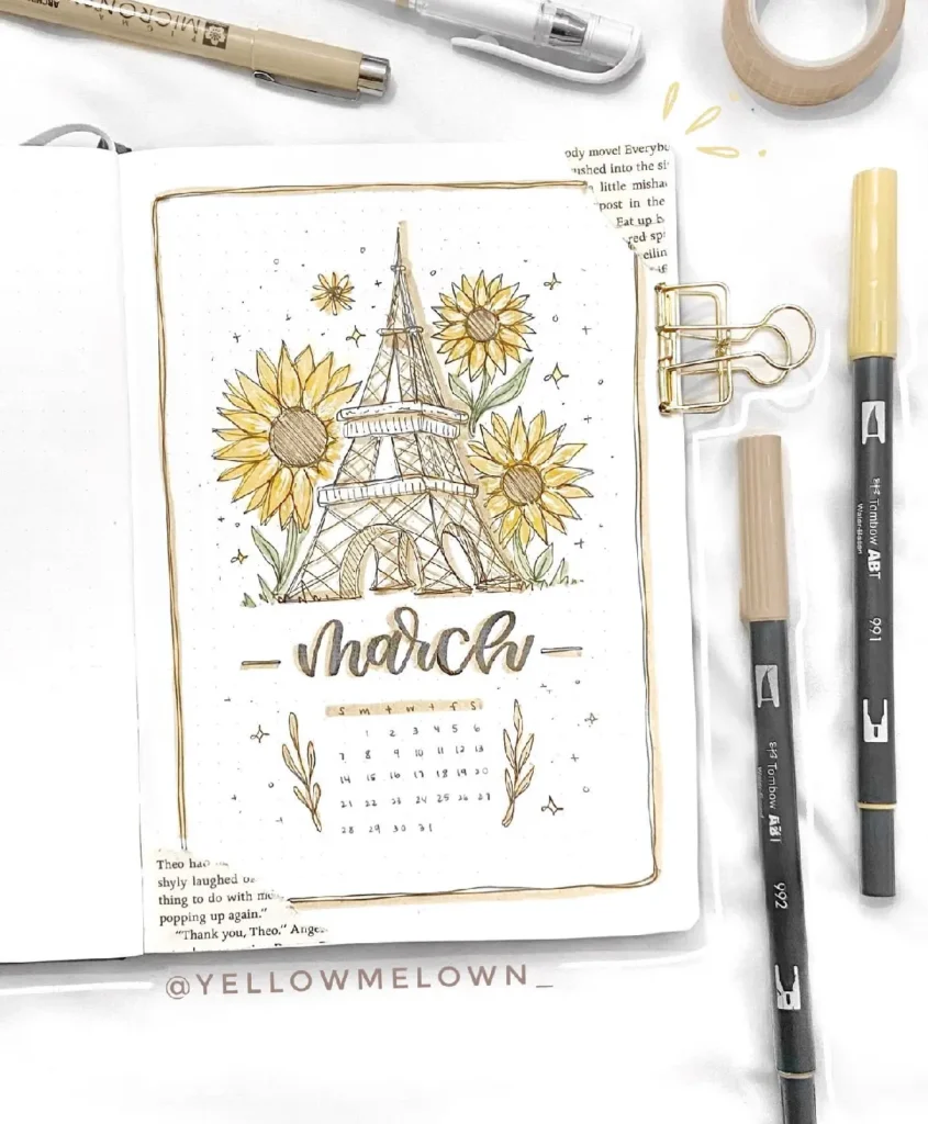 Hand-drawn bullet journal page for March featuring the Eiffel Tower and sunflowers, surrounded by art supplies.